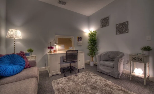 The image depicts a cozy, softly lit room designed for comfort and relaxation.